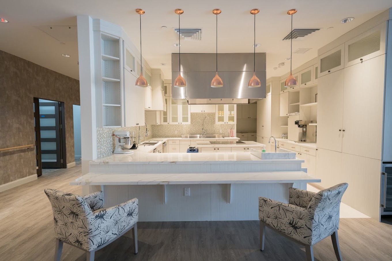 Spacious kitchen with modern appliances and marble countertops.