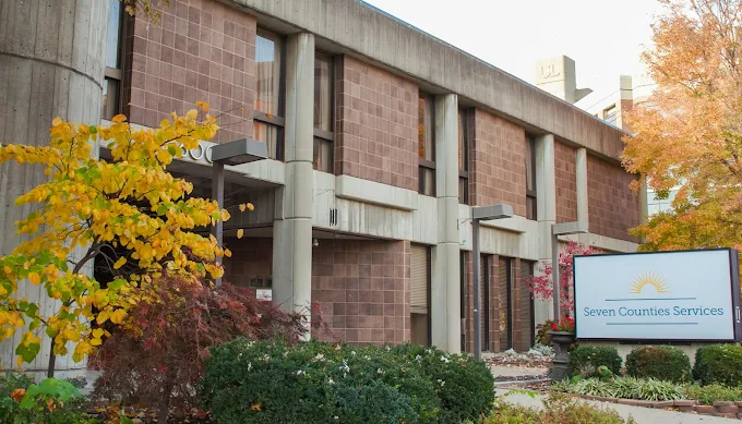 Building exterior with sign and landscaped greenery