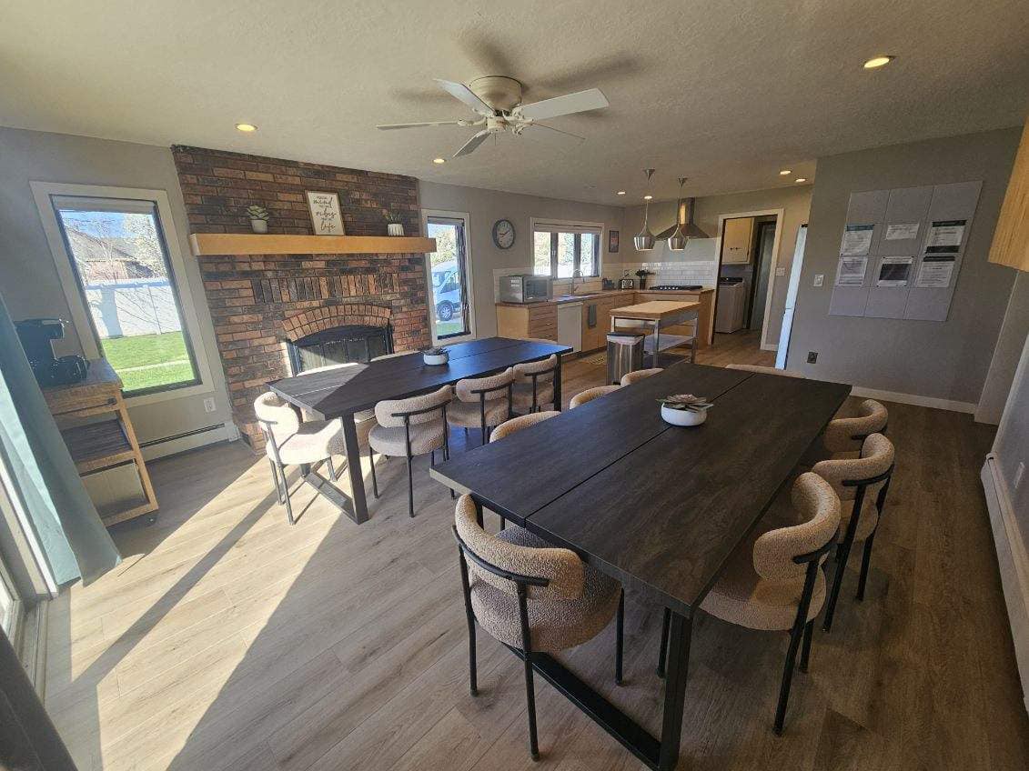 Dining room with brick fireplace and open kitchen