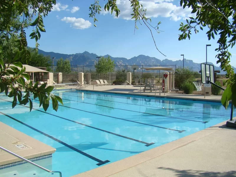 Outdoor lap pool with mountain views and lounge chairs