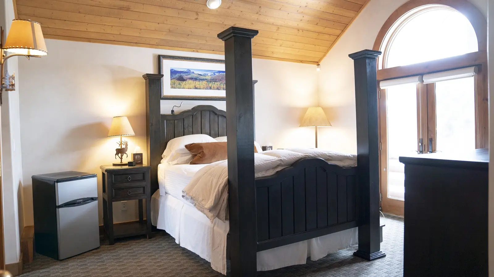 Private bedroom with a four-poster bed and rustic decor