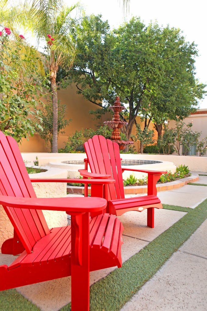 Backyard area with chairs near a fountain.